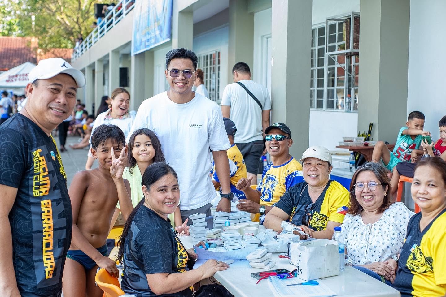 Barracudas parents volunteering at a swim meet